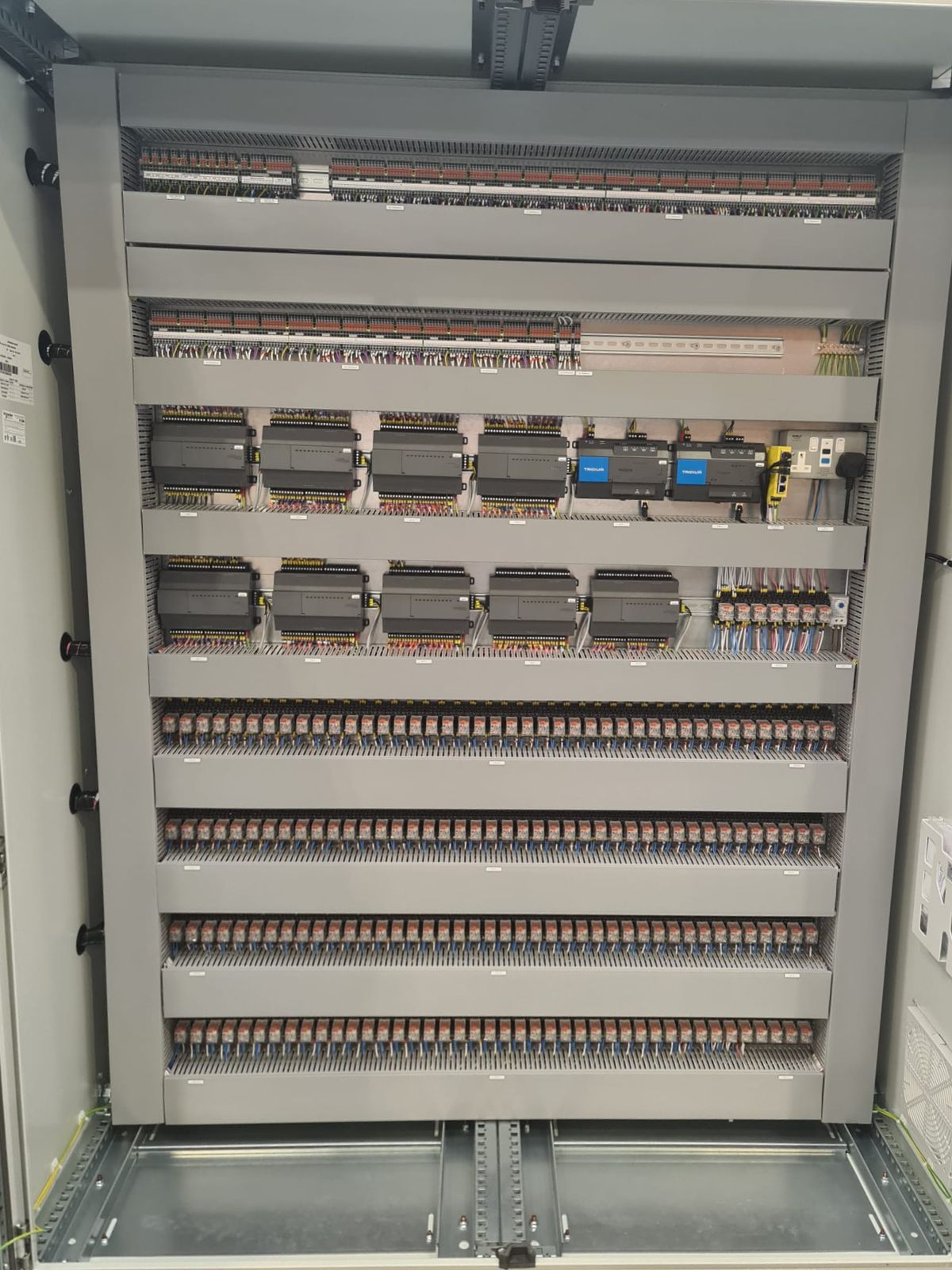 Rows of DIN rail and terminals in a BMS panel