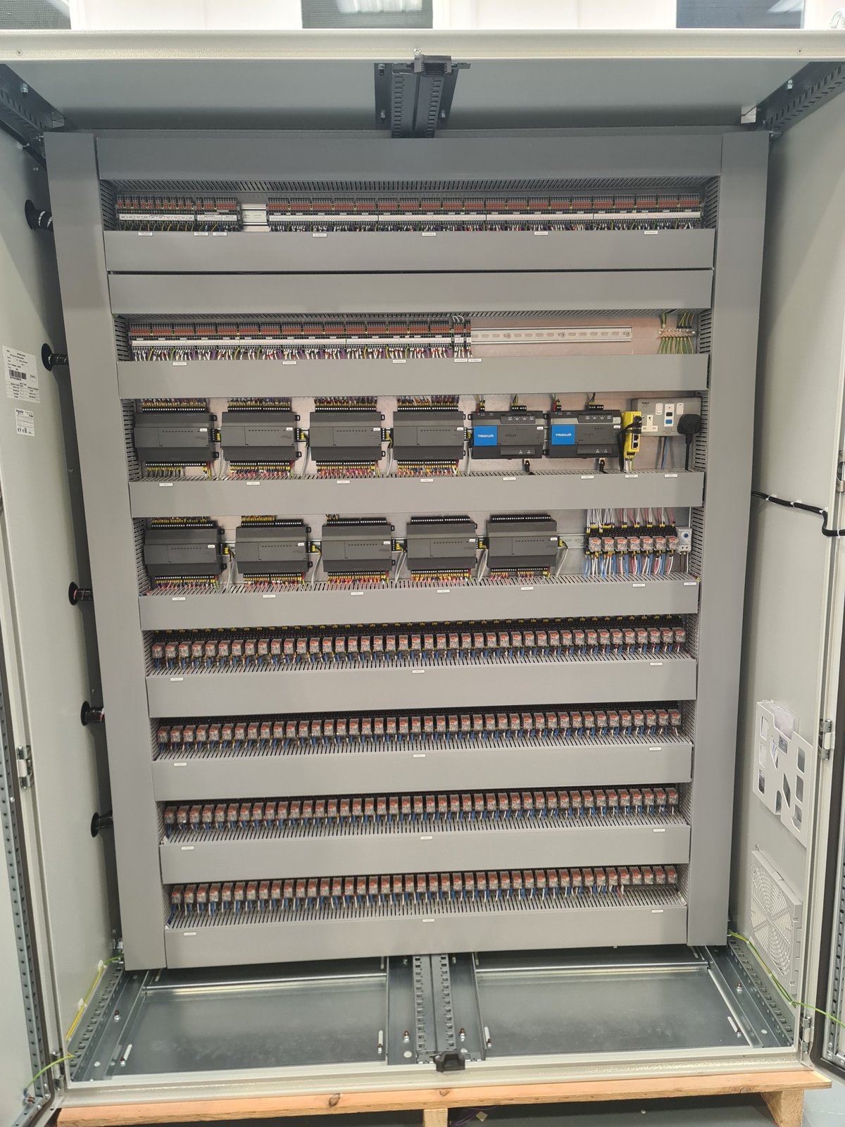 Rows of relays and terminals for the BMS interface inside the panel