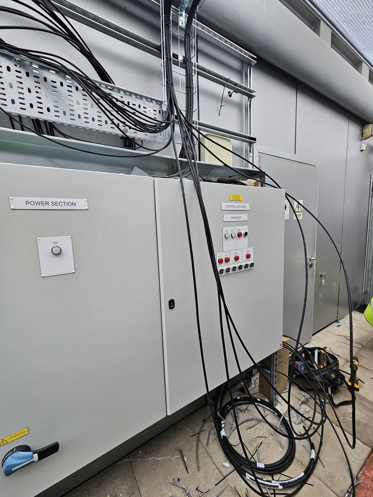 A plant room panel with the containment and field cabling being installed above it