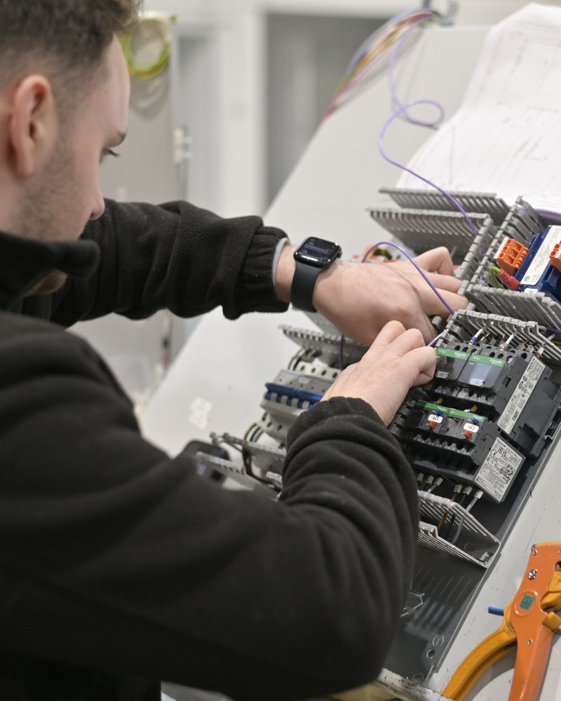 A G&G engineer wiring a control panel