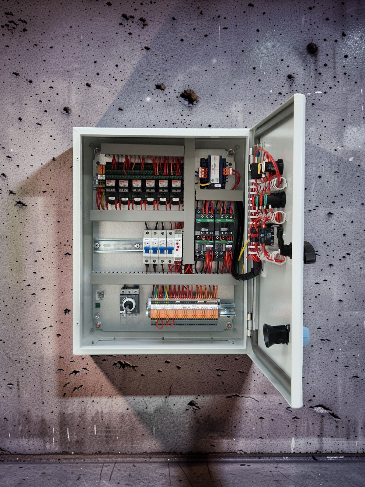 Open door of a G&G pump control panel showing contactors, overloads and WAGO terminals